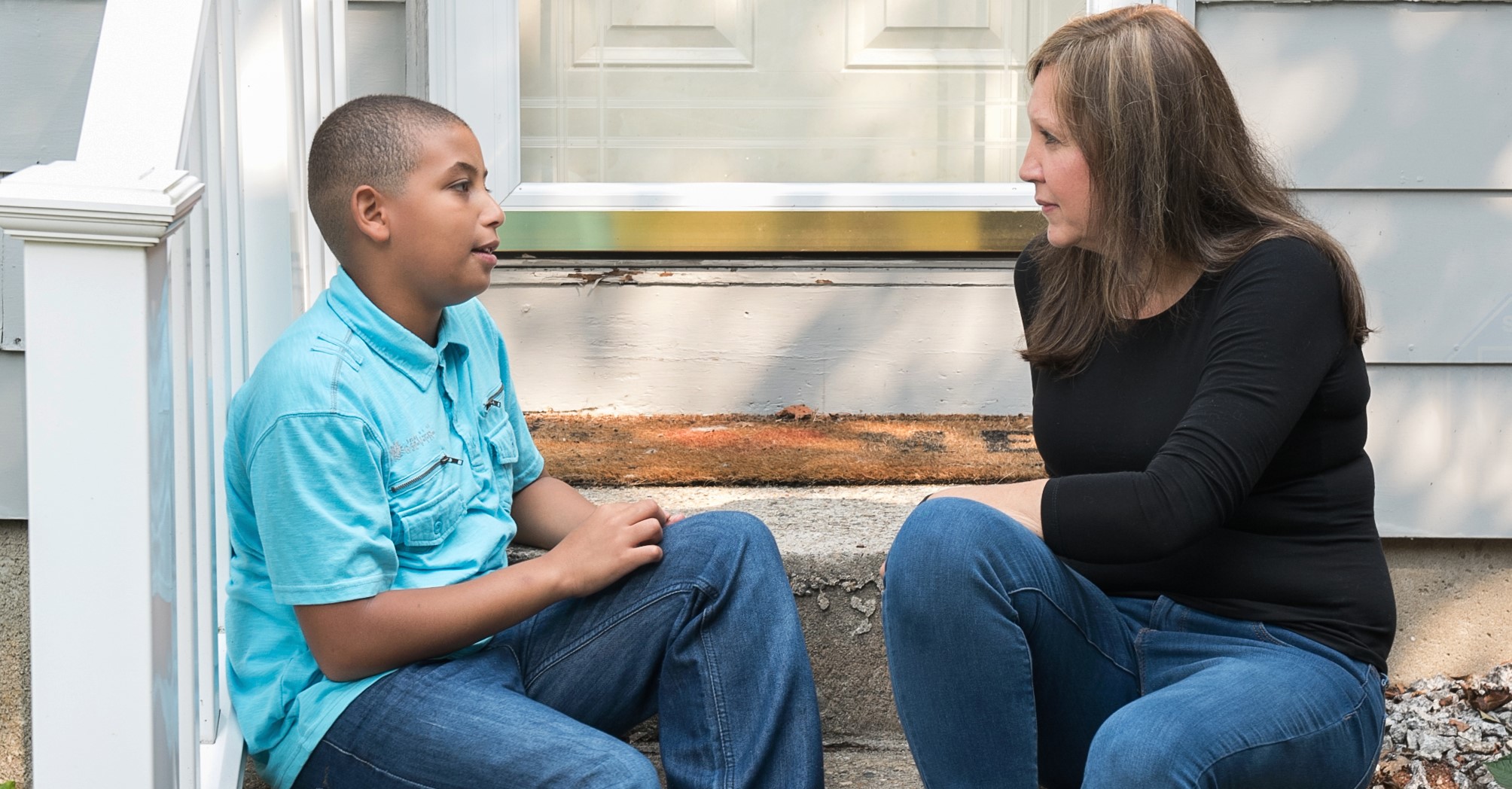 CASA of NH Volunteer Advocate with Child on Steps