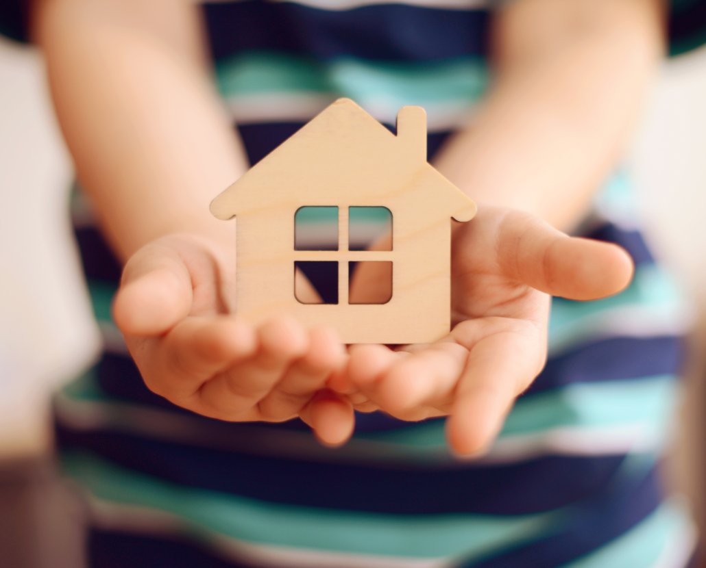 little boy holds in hands small toy house