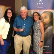CASA of NH Program Manager Shiloh Remillard, left, and CASA of NH President Marty Sink present CASA Volunteer Advocate Mark Linehan with the 2021 Linda Egbert Outstanding Advocacy Award.
