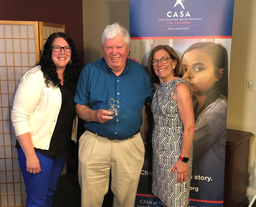 CASA of NH Program Manager Shiloh Remillard, left, and CASA of NH President Marty Sink present CASA Volunteer Advocate Mark Linehan with the 2021 Linda Egbert Outstanding Advocacy Award.